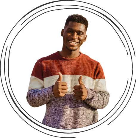 Smiling man wearing a color-block sweater giving two thumbs up.